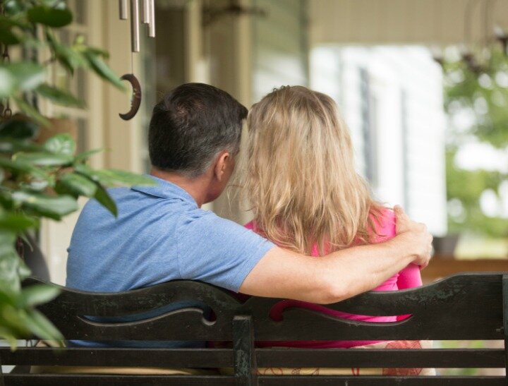 Couple sitting on a porch swing